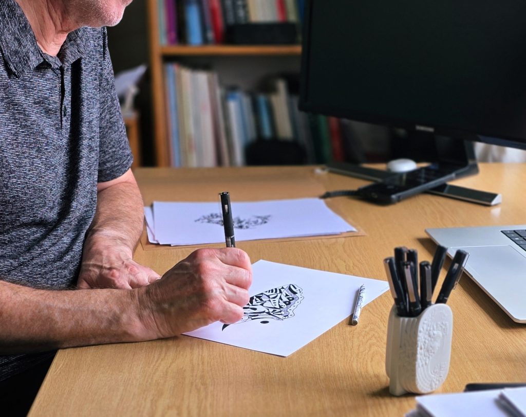 Martin drawing at his desk